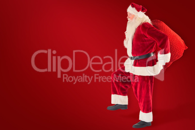 Composite image of santa jumps with his bag