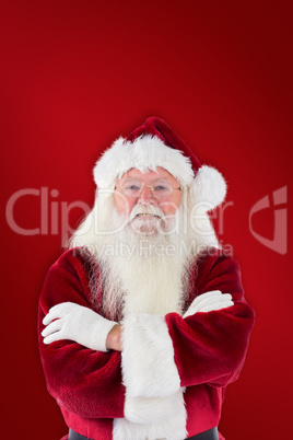 Composite image of santa smiles with folded arms