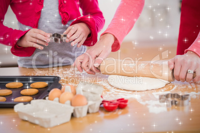 Composite image of festive mother and daughter making christmas