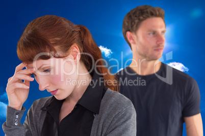 Composite image of worried woman with man behind