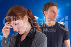 Composite image of worried woman with man behind
