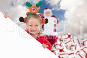 Composite image of festive little girl showing poster
