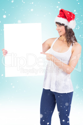 Pretty girl in santa hat holding poster Pretty girl in santa hat holding poster
