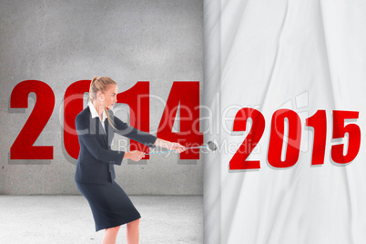 Composite image of focused blonde businesswoman pulling a rope