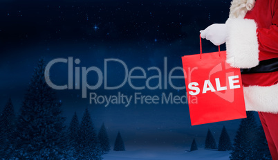 Composite image of santa claus holding sale bag