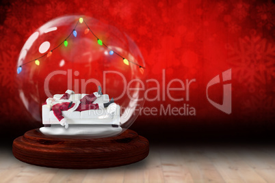 Santa sleeping in snow globe