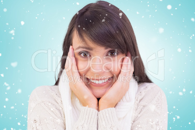 Composite image of brunette in winter clothes smiling at camera