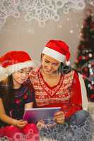 Composite image of festive mother and daughter using tablet