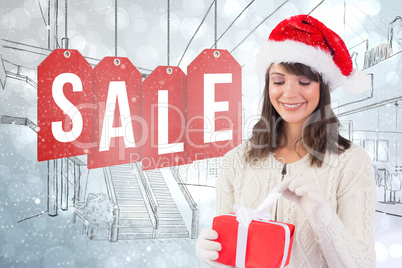 Composite image of festive brunette in santa hat opening a gift