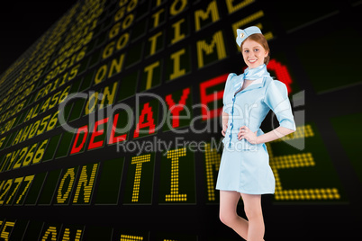 Composite image of pretty air hostess with hand on hip