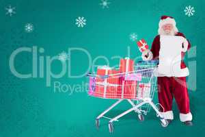 Composite image of santa spread presents with shopping cart