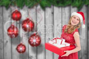 Composite image of woman holding present