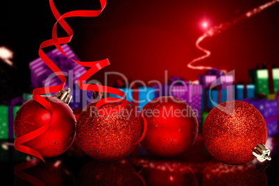 Composite image of four red christmas ball decorations