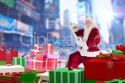 Composite image of santa delivering gifts from cart