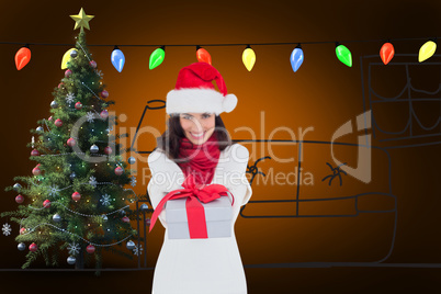 Composite image of festive brunette in santa hat giving gift