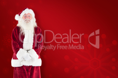 Composite image of jolly santa smiling at camera