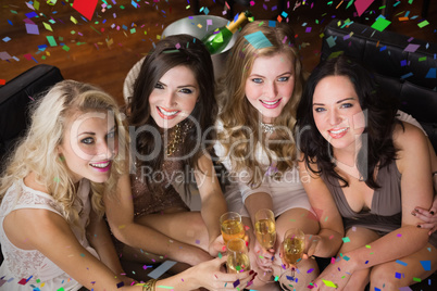 Composite image of pretty friends having a drink together