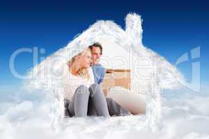 Composite image of lovely couple sitting on the floor