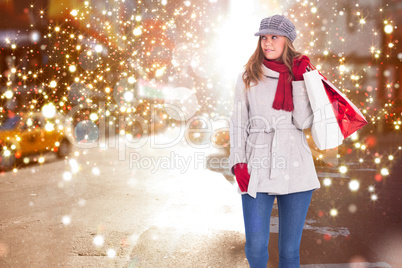 Composite image of happy blonde in winter clothes with bags