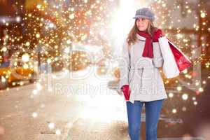 Composite image of happy blonde in winter clothes with bags