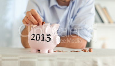 Composite image of change being put into piggy bank