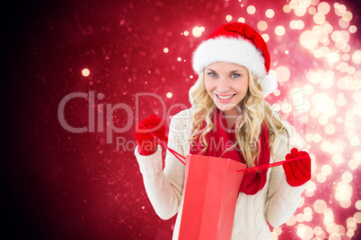 Composite image of happy festive blonde with shopping bag