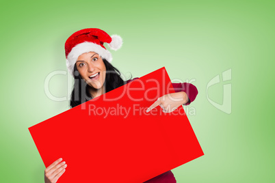 Composite image of woman pointing at sign