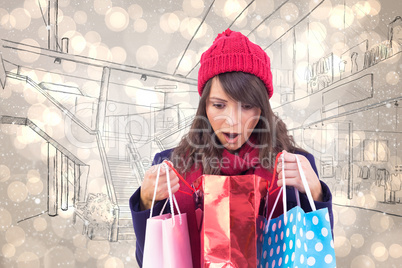 Composite image of shocked brunette opening gift bag