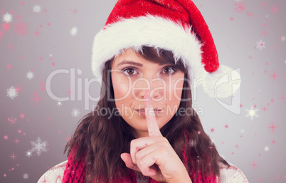 Composite image of portrait of a brunette keeping a secret