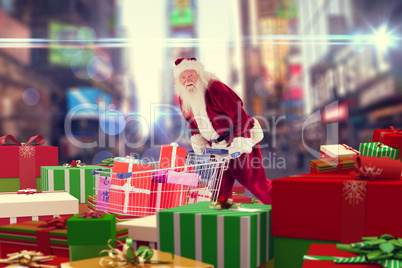 Composite image of santa delivering gifts from cart