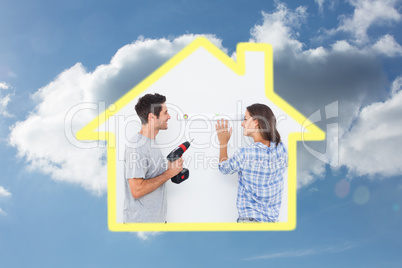 Composite image of cheerful man and his wife doing home improvem