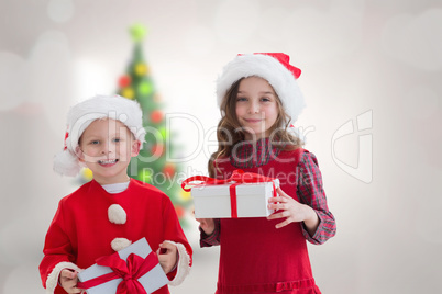 Composite image of cute siblings with gifts