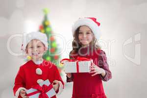 Composite image of cute siblings with gifts