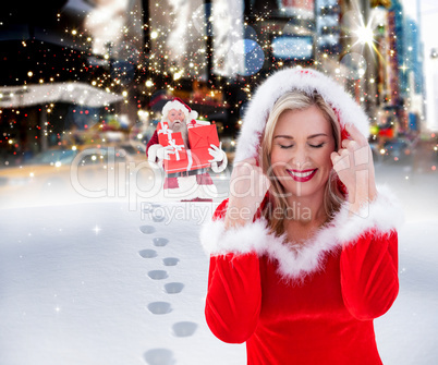 Composite image of festive blonde with hood up