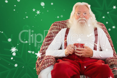 Composite image of father christmas sitting on the armchair hold