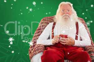 Composite image of father christmas sitting on the armchair hold
