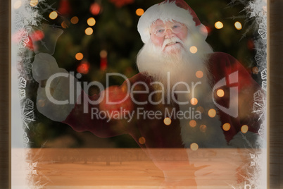 Composite image of santa claus rings his bell