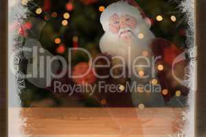 Composite image of santa claus rings his bell