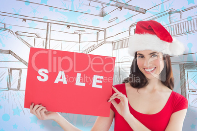 Composite image of festive brunette with sale sign Composite image of festive brunette with sale sign