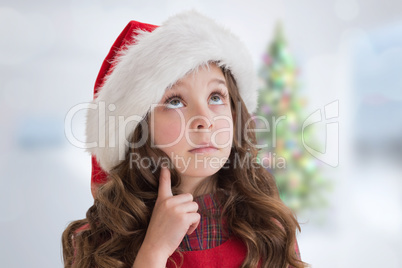 Composite image of cute girl in santa hat