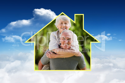 Composite image of man giving wife a piggyback