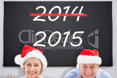 Composite image of festive couple showing poster