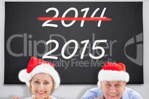 Composite image of festive couple showing poster