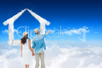 Composite image of happy hipster couple holding hands and lookin