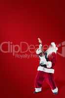 Composite image of santa playing electric guitar