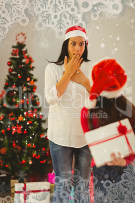 Composite image of daughter surprising her mother with christmas gift