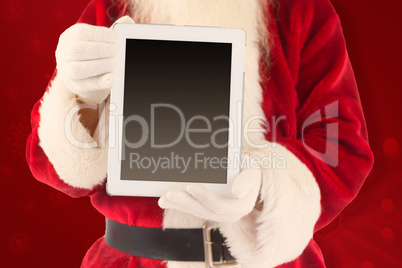 Composite image of santa claus showing tablet pc