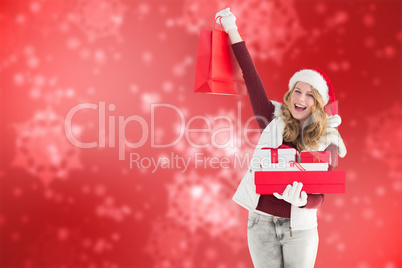 Composite image of festive blonde with shopping bag and gifts