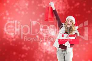 Composite image of festive blonde with shopping bag and gifts