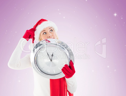 Festive blonde holding a clock